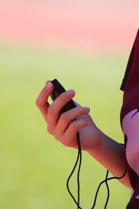 Midsection of woman holding stopwatch