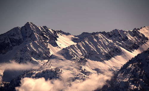 Scenic view of snowcapped mountains against clear sky