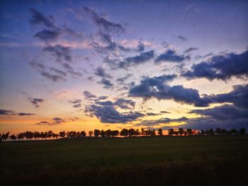 Scenic view of field against sky during sunset