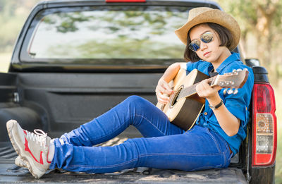 Midsection of woman holding guitar