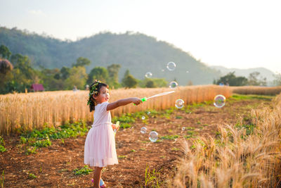 Rear view of woman standing on field