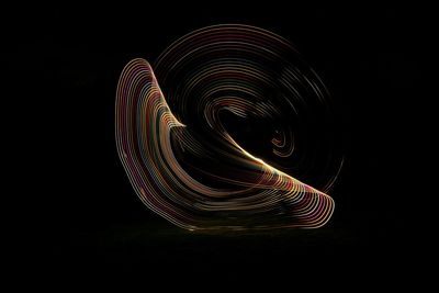 Illuminated light painting against black background