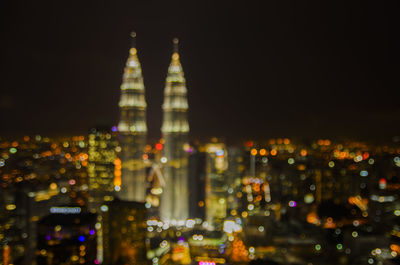 Illuminated city against sky at night