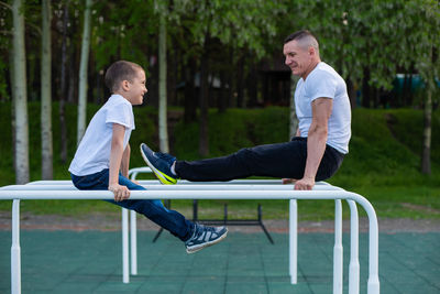 Side view of smiling young man on seat