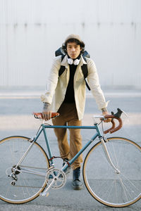 Handsome man leaning on bicycle