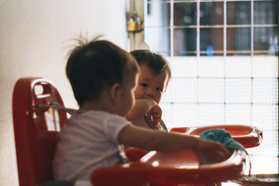 Rear view of father and son at home