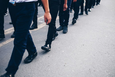 Low section of people walking on street