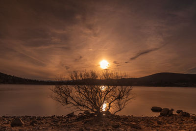 Scenic view of lake against sky during sunset