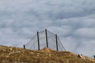 View from the mountain into the fog over a fence