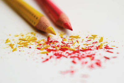 Close-up of colored pencils on white background