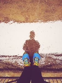 Low section of woman standing on tiled floor