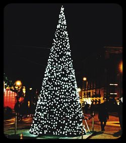 Low angle view of christmas tree at night