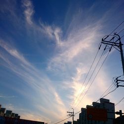 Low angle view of electricity pylon against sky