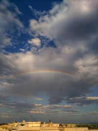 Scenic view of rainbow over buildings in city