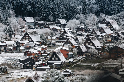 High angle view of houses and trees in city