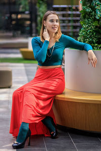 Portrait of young woman sitting on floor