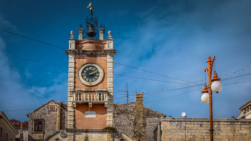 Low angle view of clock tower against sky