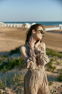 Side view of woman standing at beach