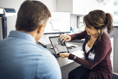 Female doctor explaining report to patient in clinic