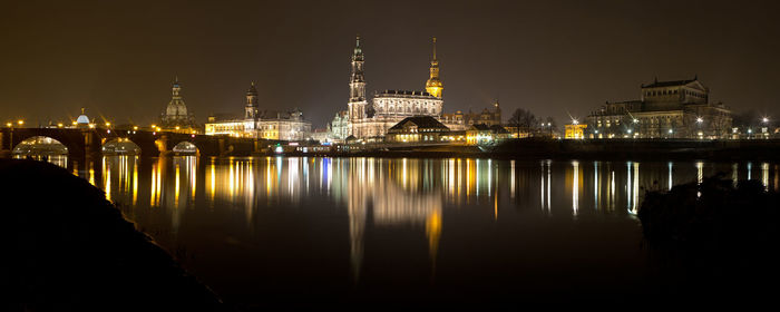 Reflection of illuminated buildings in water at night