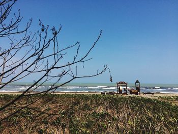 Scenic view of sea against clear blue sky