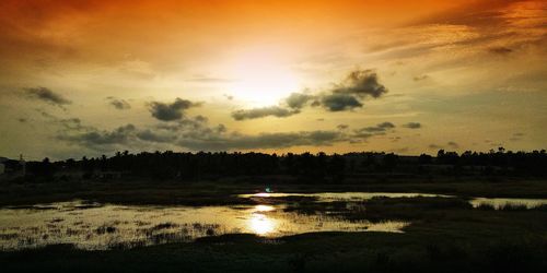 Scenic view of lake against sky during sunset