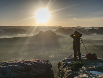 Girl frind photographer artist working on edge. view point on high mountain peak with circle view