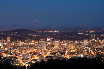 High angle view of illuminated cityscape against sky at night