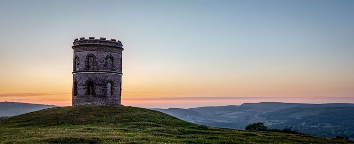 Old built structure against sky during sunset