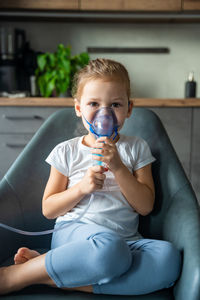 Portrait of young woman drinking water from car