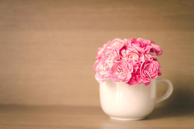 Close-up of pink flower vase on table