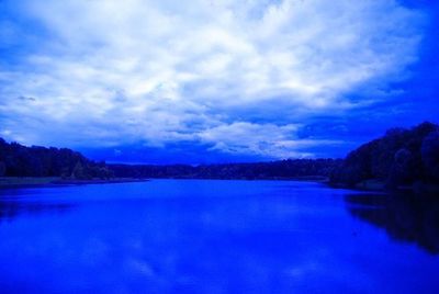 Scenic view of lake against sky at sunset