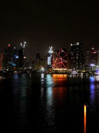 Illuminated city at waterfront