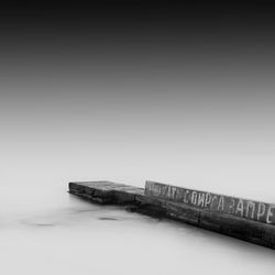 Pier by sea against sky during foggy weather