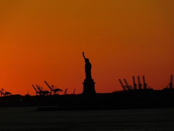 Silhouette of statue at sunset