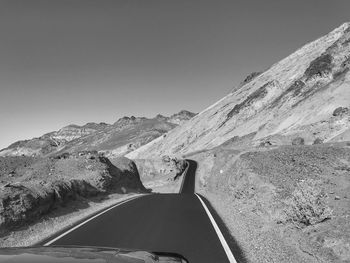 Road by mountain against clear sky