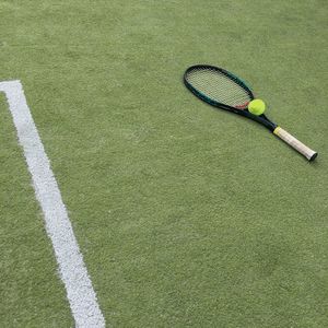 High angle view of ball and racket on tennis court