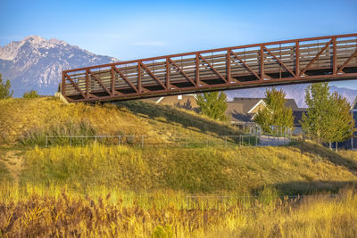 View of bridge on field against sky