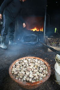 Full length of man preparing food on barbecue grill