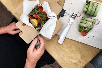 Cropped image of person having lunch at table