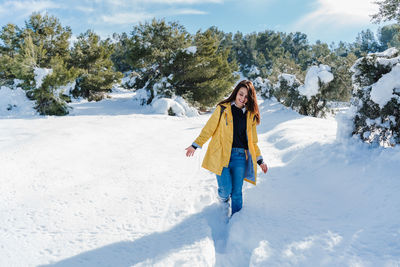 Woman walking on snow covered land