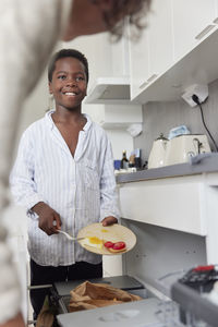 Boy cleaning up after meal