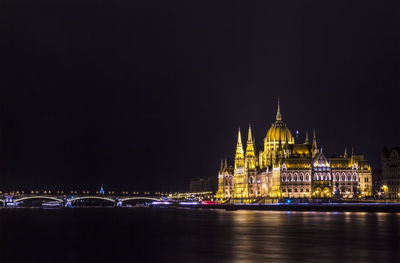 Hungarian parliament building by danube river at night
