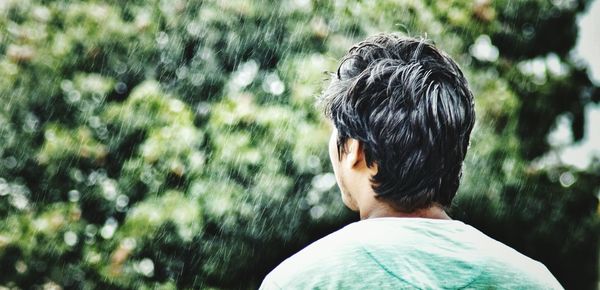 Rear view of man against trees