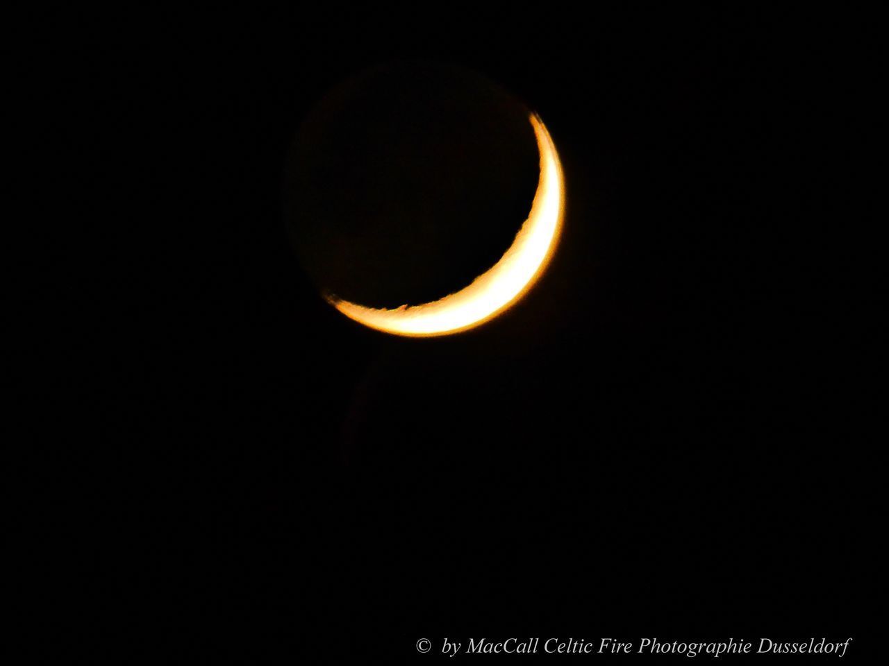 LOW ANGLE VIEW OF MOON AGAINST BLACK SKY