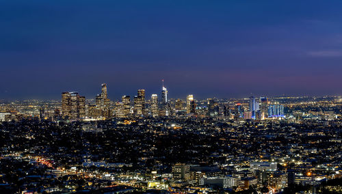 High angle view of illuminated buildings against sky at night