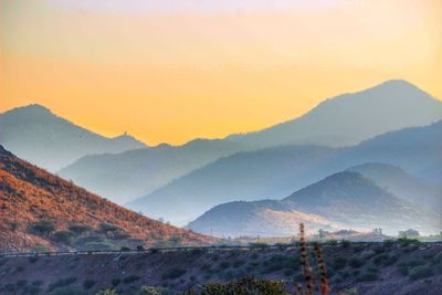 Scenic view of mountains against clear sky during sunset