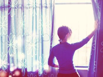 Close-up of woman standing on bed