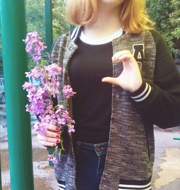 MIDSECTION OF WOMAN PHOTOGRAPHING WITH MOBILE PHONE WHILE STANDING ON CAMERA OUTDOORS