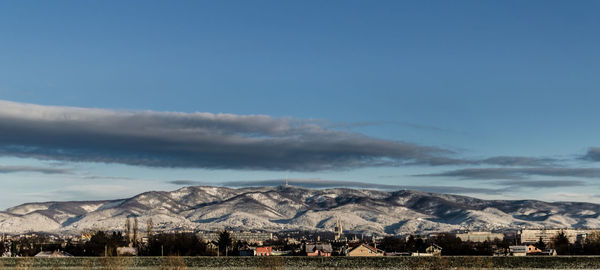 Scenic view of snowcapped mountains against blue sky at dusk